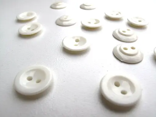Gombík dvojdierkový košeľový s jamkou 13mm/smotanový